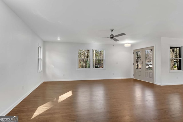 unfurnished room with dark hardwood / wood-style flooring, ceiling fan, and a healthy amount of sunlight