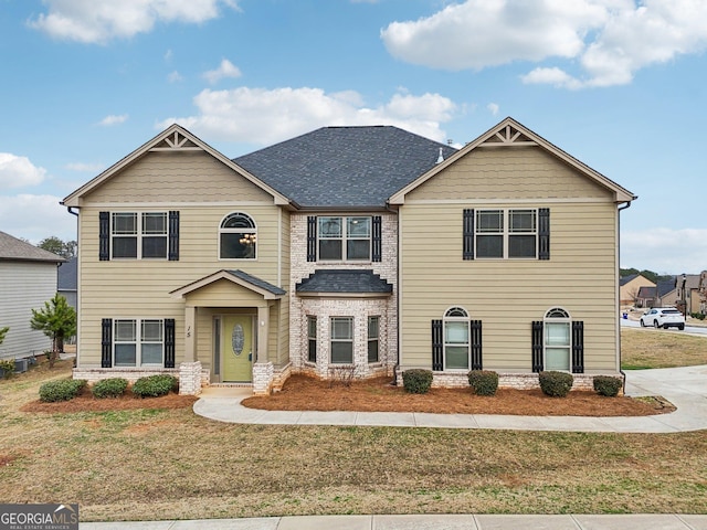 craftsman-style house with a front lawn