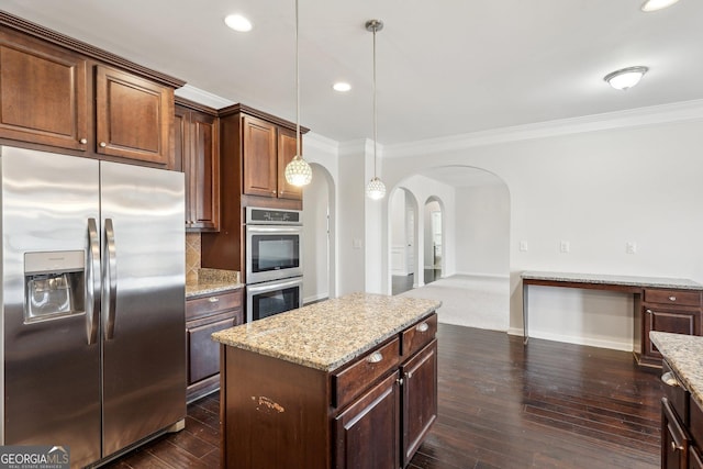 kitchen featuring hanging light fixtures, stainless steel appliances, crown molding, and a center island