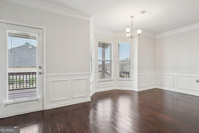 unfurnished dining area featuring a wainscoted wall, crown molding, visible vents, an inviting chandelier, and dark wood-type flooring