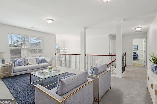 living room featuring a chandelier, baseboards, visible vents, and ornate columns