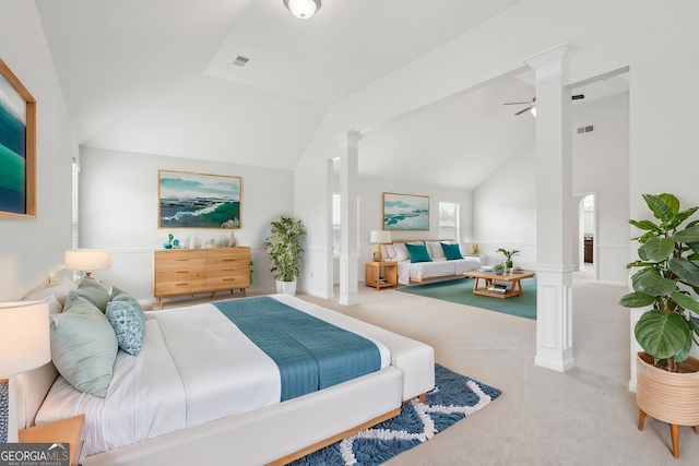 carpeted bedroom featuring lofted ceiling, ornate columns, and visible vents