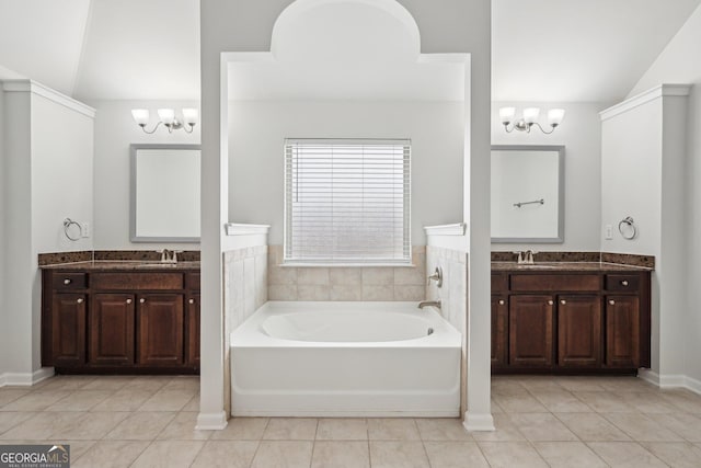 full bath with lofted ceiling, a sink, and an inviting chandelier