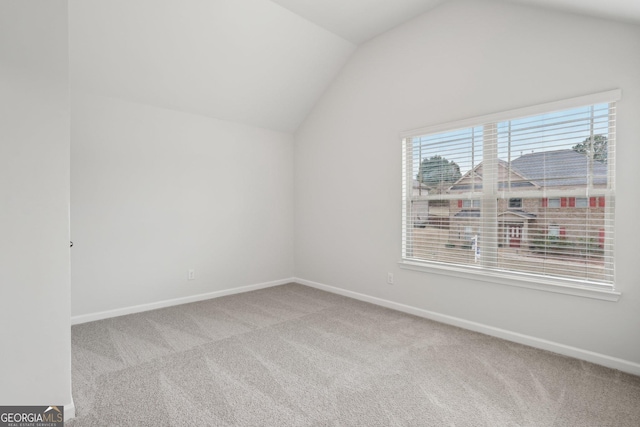 bonus room featuring light carpet, vaulted ceiling, and baseboards