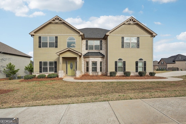 craftsman-style home featuring a front lawn