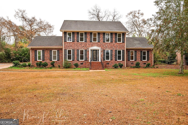 4804 Brittany Dr, Macon, GA 31210 - colonial-style house featuring brick siding, a front lawn, and a shingled roof