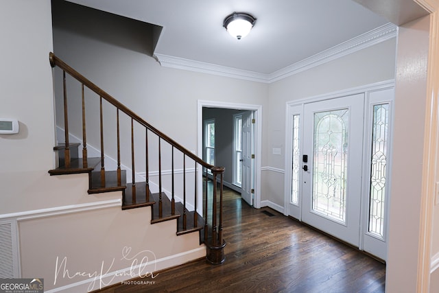 entryway featuring ornamental molding and dark hardwood / wood-style floors