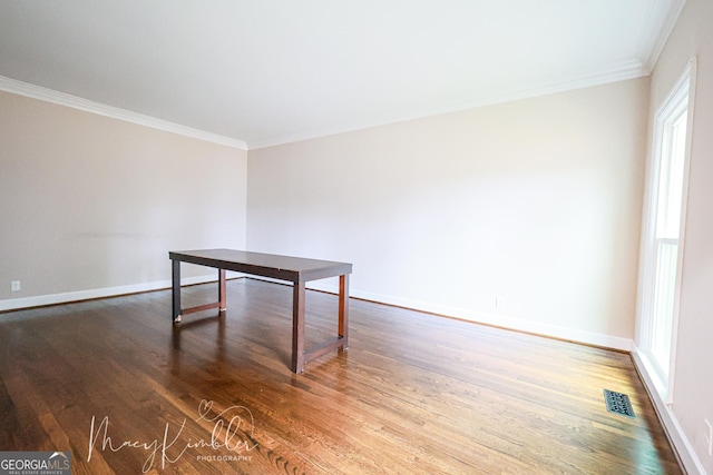 unfurnished room featuring crown molding and wood-type flooring