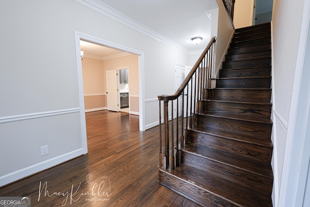 stairway with hardwood / wood-style floors and ornamental molding