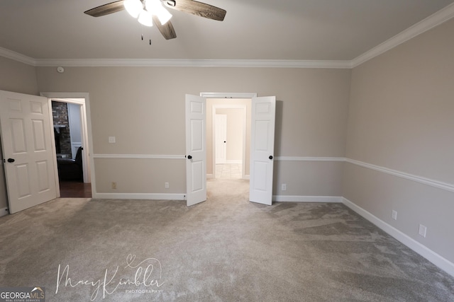 unfurnished bedroom featuring crown molding, carpet flooring, and ceiling fan