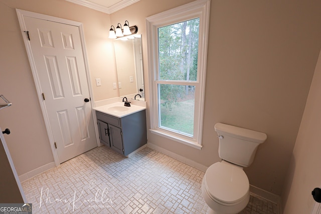 bathroom with vanity, ornamental molding, a wealth of natural light, and toilet