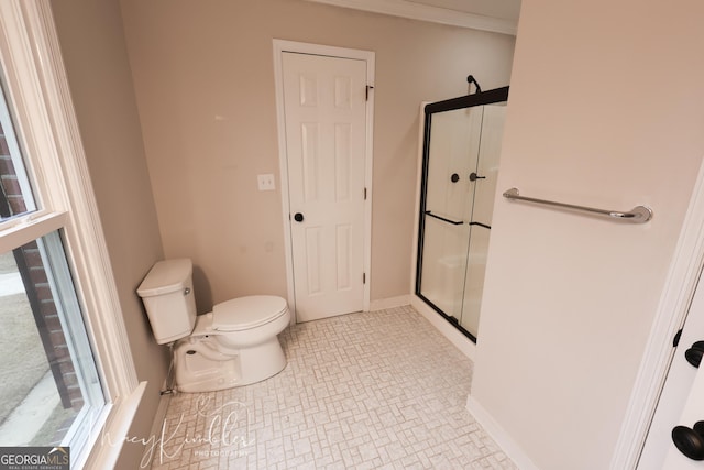 bathroom with toilet and a shower with door