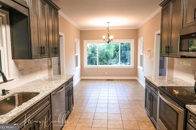 kitchen featuring pendant lighting, sink, appliances with stainless steel finishes, light stone counters, and dark brown cabinetry