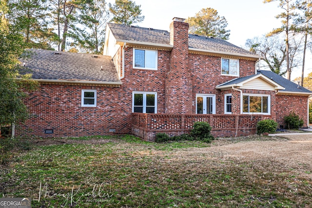 back of house with a lawn