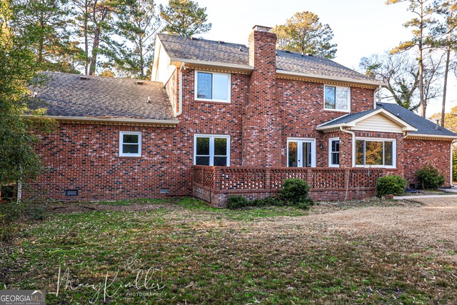 4804 Brittany Dr, Macon, GA 31210 - rear view of property featuring a chimney, roof with shingles, brick siding, and a wooden deck