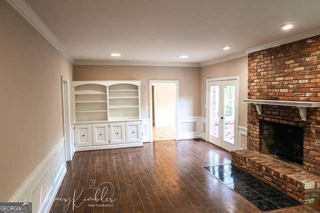 4804 Brittany Dr, Macon, GA 31210 - unfurnished living room featuring a decorative wall, french doors, dark wood finished floors, a wainscoted wall, and a fireplace