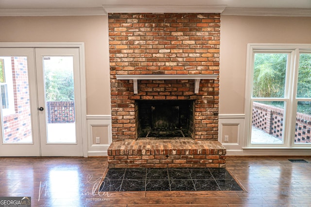 4804 Brittany Dr, Macon, GA 31210 - unfurnished living room with hardwood / wood-style flooring, crown molding, healthy amount of natural light, french doors, and a wainscoted wall