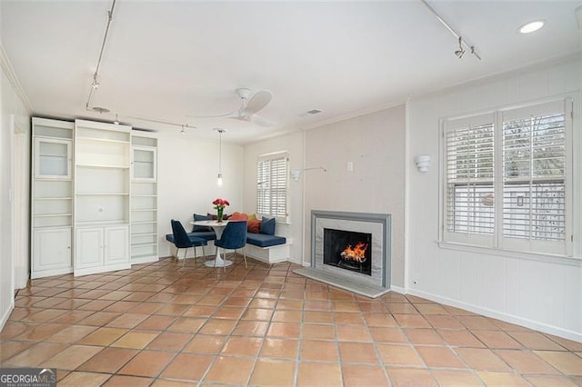 unfurnished room featuring light tile patterned floors, crown molding, rail lighting, and ceiling fan