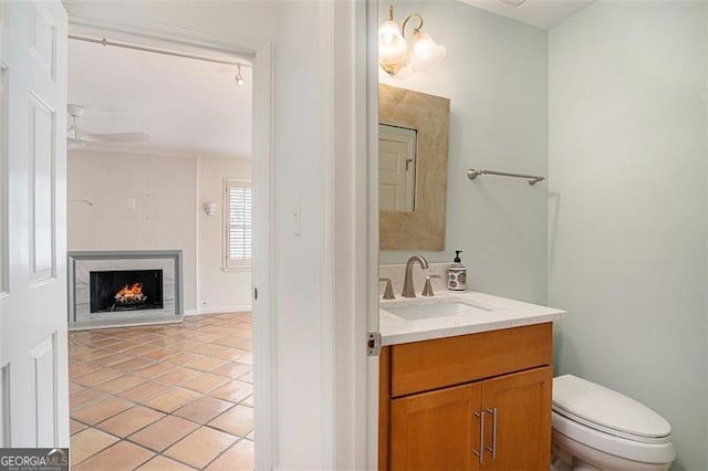 bathroom featuring vanity, tile patterned floors, toilet, and ceiling fan