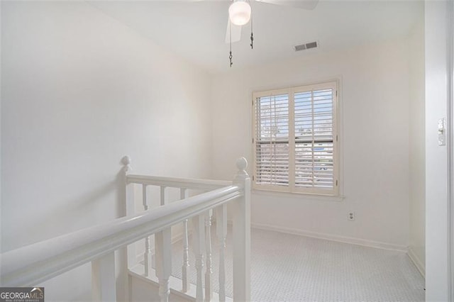 hall featuring light colored carpet