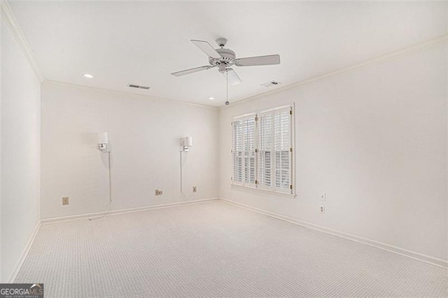 carpeted spare room with crown molding and ceiling fan