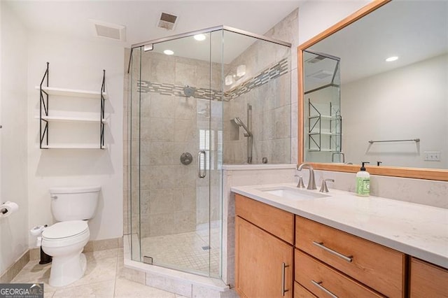 bathroom with tile patterned flooring, vanity, walk in shower, and toilet