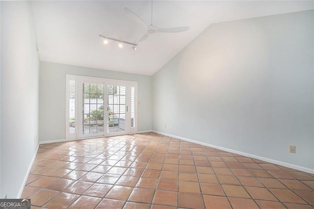 tiled spare room with ceiling fan, lofted ceiling, and track lighting