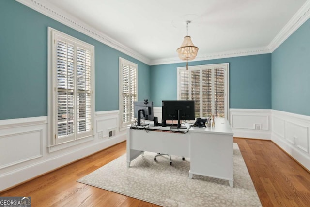 home office with crown molding and light wood-type flooring