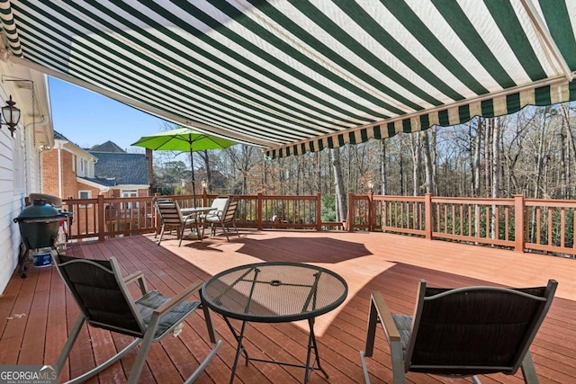 wooden terrace featuring a grill