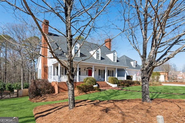 cape cod-style house featuring a front yard and covered porch