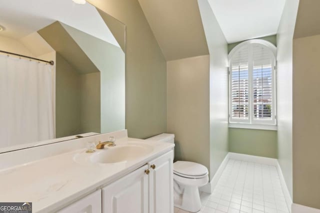 bathroom with vaulted ceiling, vanity, toilet, and tile patterned flooring