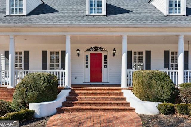 view of exterior entry featuring a porch