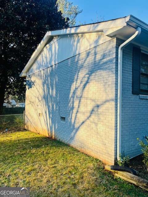 view of side of property with a lawn