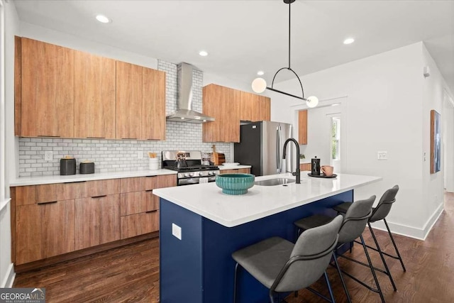kitchen featuring modern cabinets, appliances with stainless steel finishes, and wall chimney exhaust hood