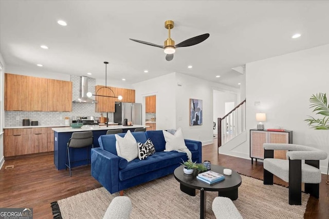 living room with recessed lighting, stairs, ceiling fan, and dark wood-style flooring