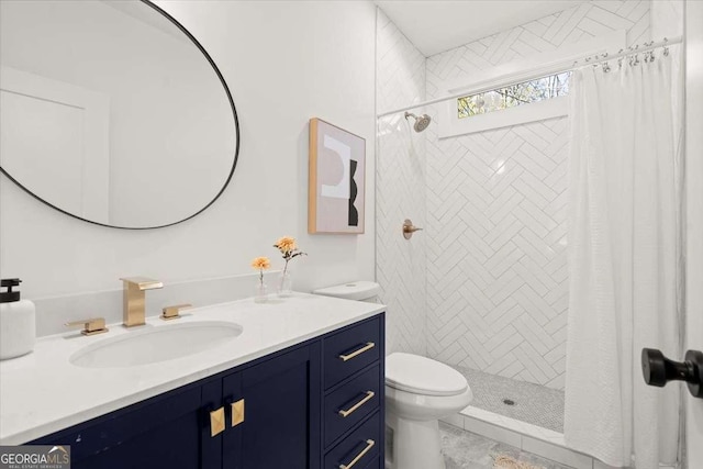 bathroom with vanity, toilet, and a stall shower