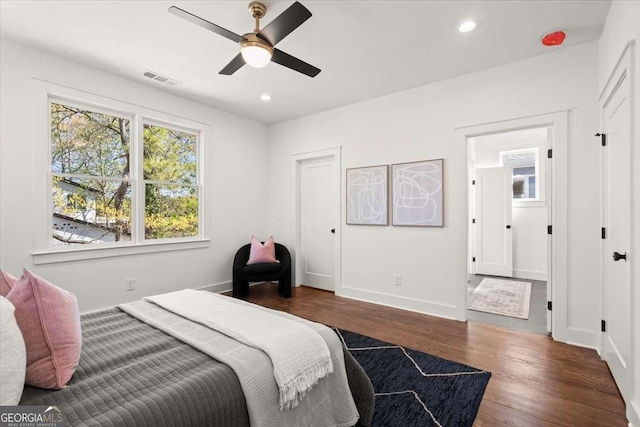 bedroom with visible vents, baseboards, ceiling fan, dark wood finished floors, and recessed lighting