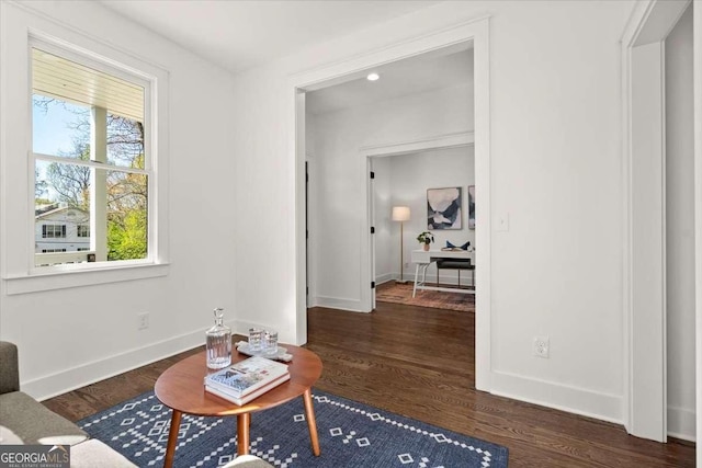 living area with wood finished floors and baseboards