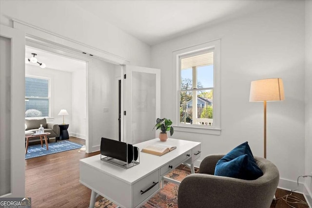 office with wood finished floors and baseboards