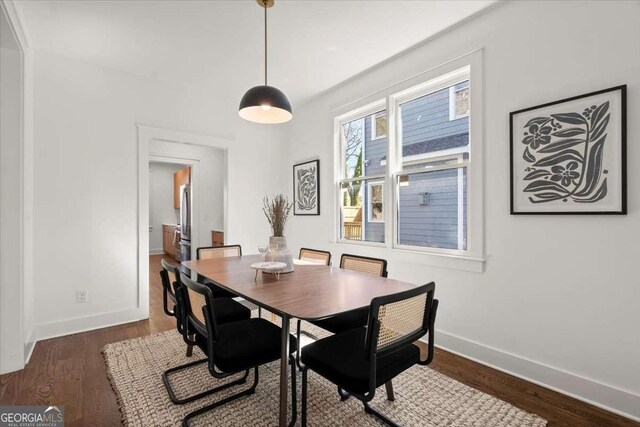 dining space with wood finished floors and baseboards