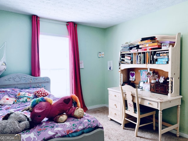 bedroom with light colored carpet and a textured ceiling