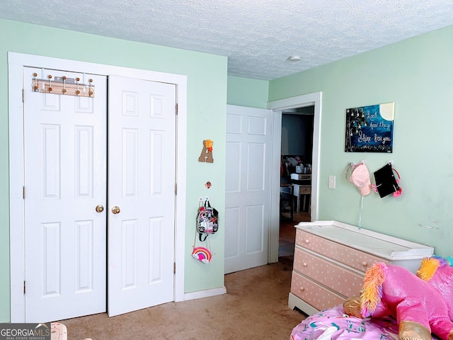 carpeted bedroom featuring a closet and a textured ceiling