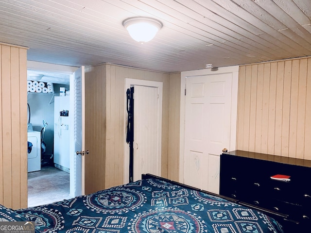 unfurnished bedroom with washer / dryer, wooden walls, white refrigerator with ice dispenser, and wood ceiling