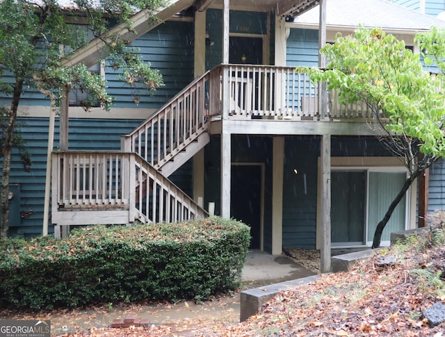 rear view of property with stairway