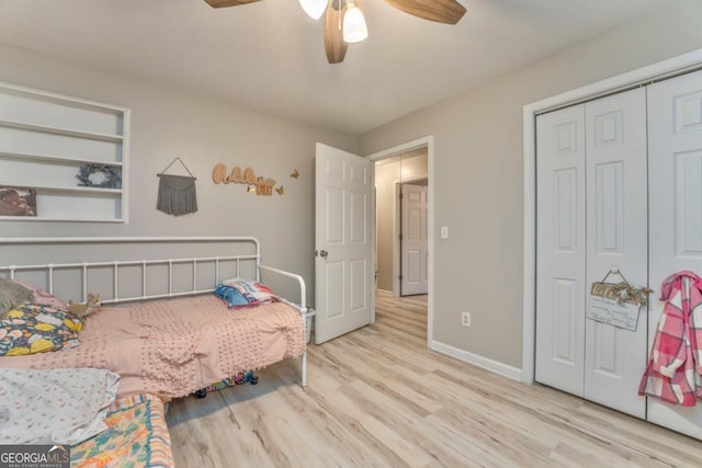 bedroom with light hardwood / wood-style floors, a closet, and ceiling fan