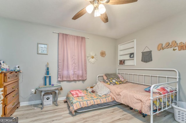 bedroom with light hardwood / wood-style flooring and ceiling fan