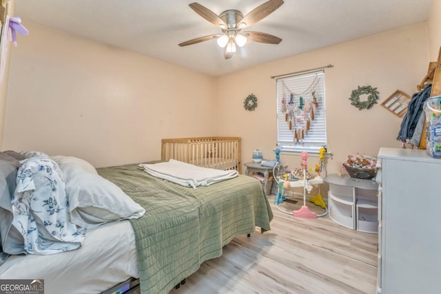 bedroom with light hardwood / wood-style flooring and ceiling fan