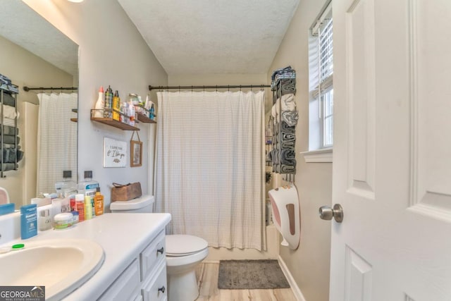 full bathroom with shower / tub combo with curtain, toilet, a textured ceiling, vanity, and hardwood / wood-style floors