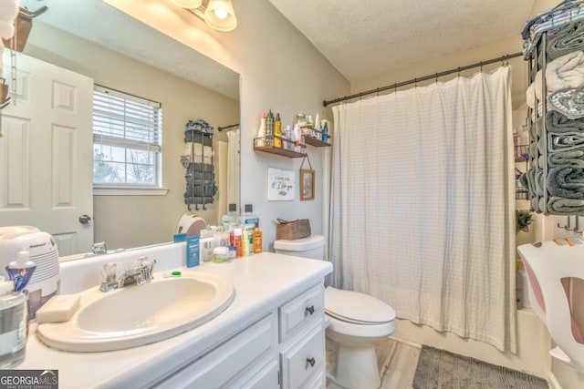 full bathroom with vanity, toilet, a textured ceiling, and shower / bathtub combination with curtain