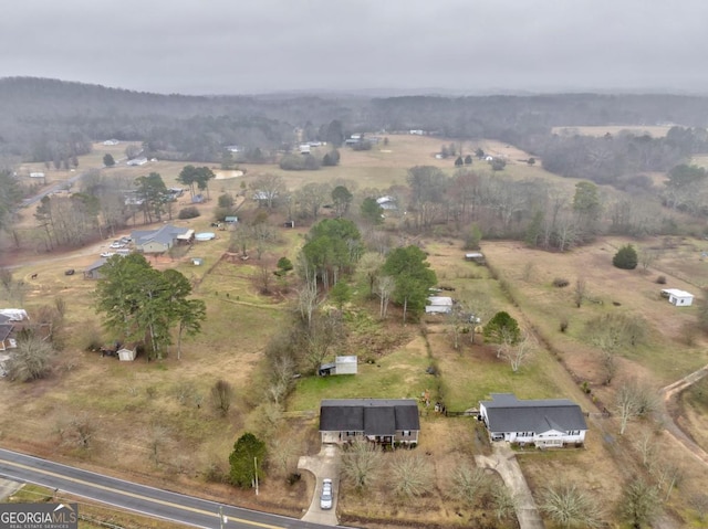 birds eye view of property with a rural view